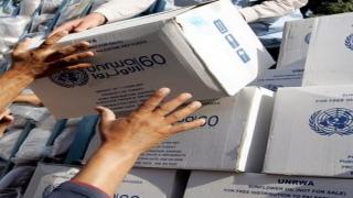 Palestinians receive food aid donated for refugees from the European Union and the World Food Programme (WFP) and distributed by the United Nations Relief and Works Agency (UNRWA) in the northern West Bank city of Jenin, on July 9, 2010. AFP PHOTO/SAIF DAHLAH (Photo credit should read SAIF DAHLAH/AFP/Getty Images)